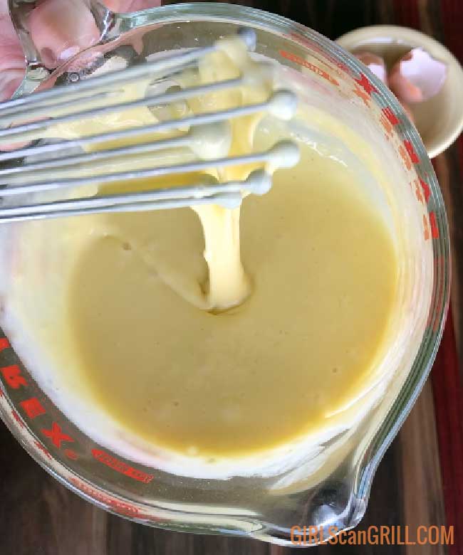 whisk lifting batter showing smooth consistency 