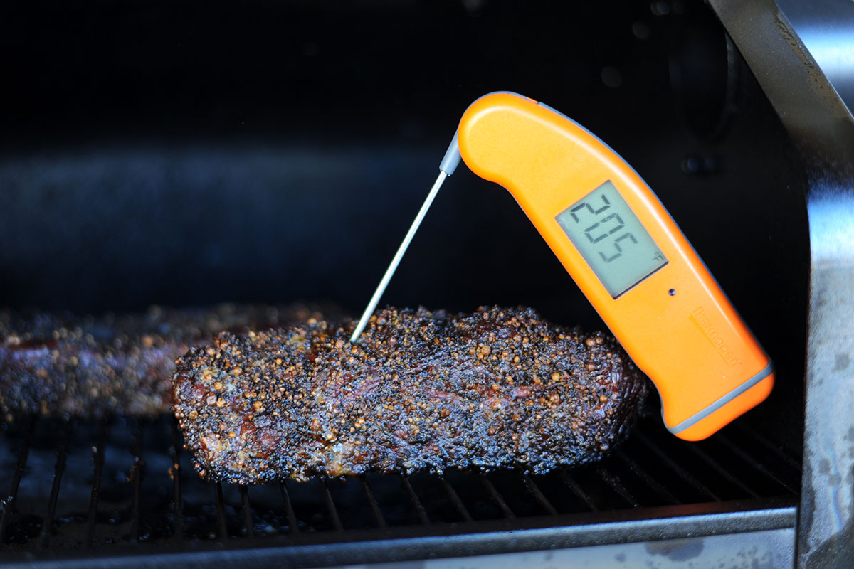 digital thermometer showing meat temp at 205F degrees.