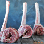 three tomahawk short ribs standing up with gray background