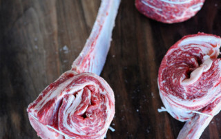 tied up Tomahawk Short Ribs on wooden background