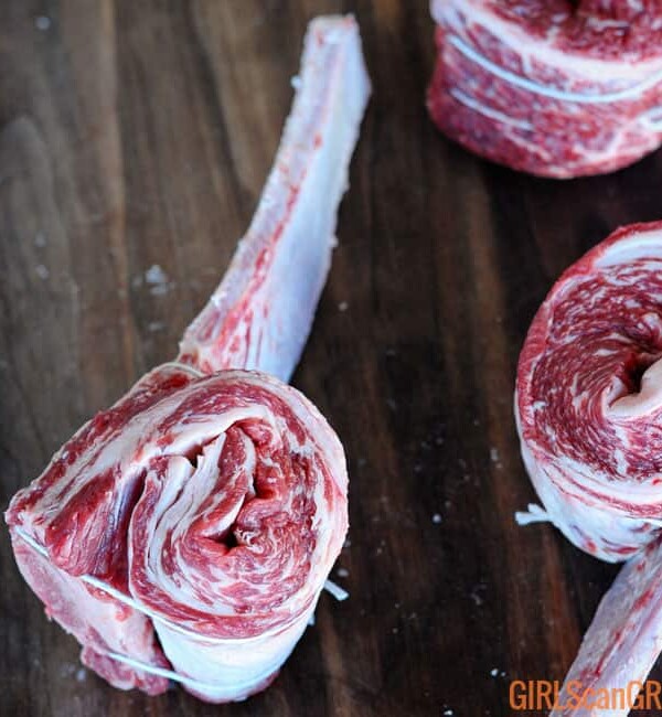 tied up Tomahawk Short Ribs on wooden background
