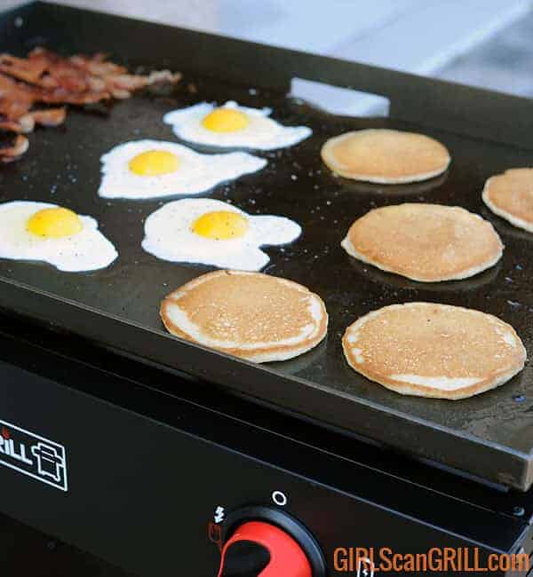 bacon, eggs and pancakes on a griddle top