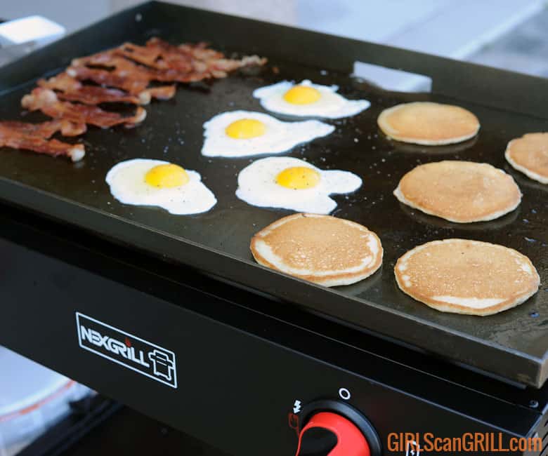 bacon, eggs and pancakes on a griddle top.