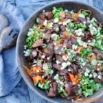 large bowl of beef bulgogi salad with peeled carrots and beef