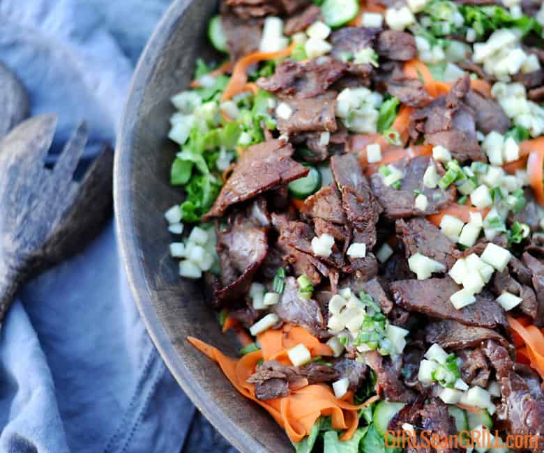 large bowl of salad with peeled carrots and beef