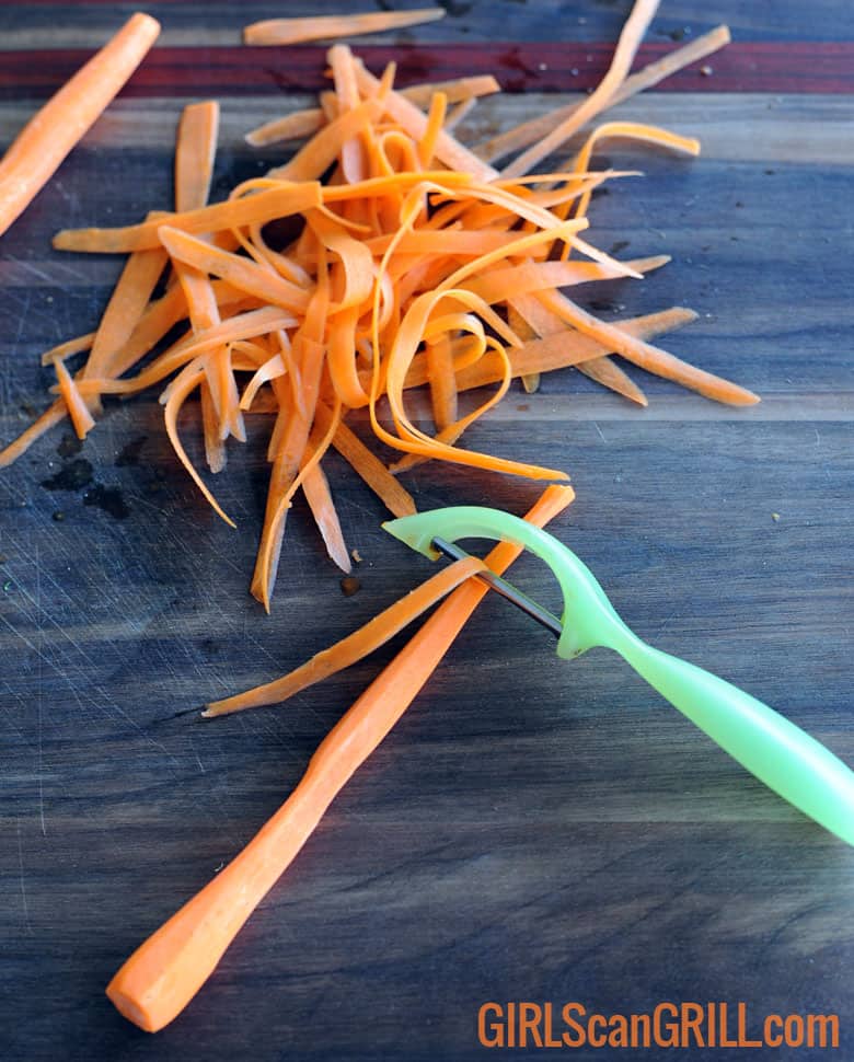peeling a carrot with strips nearby