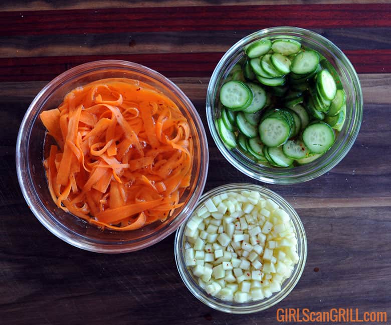 3 bowls of carrots, cucumbers and green apples in brine