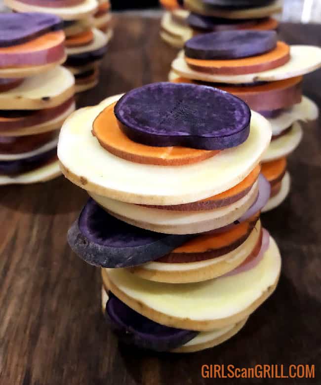 stacks of white, orange and purple sweet potato slices