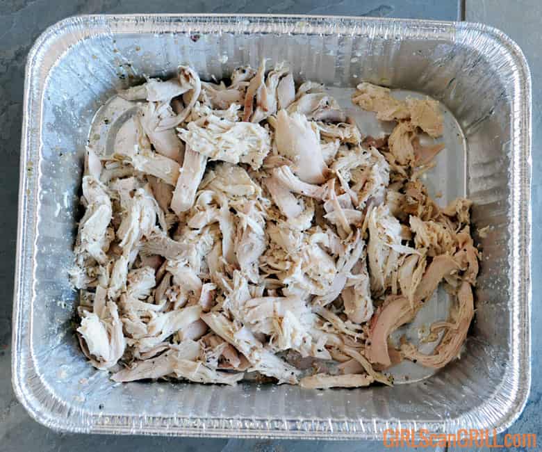 chicken pulled in an aluminum pan.