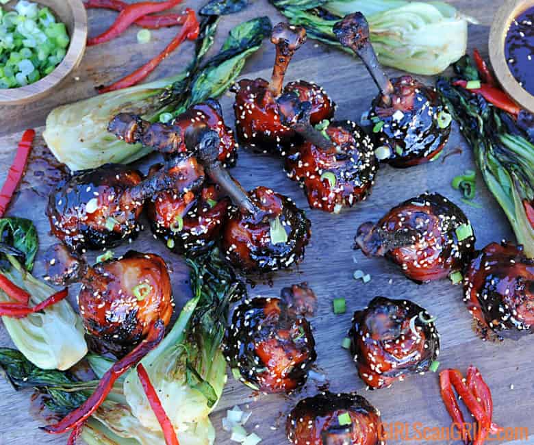 wooden platter with Asian Sticky Chicken and bok choy