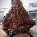 grilled porterhouse steak standing up on its end