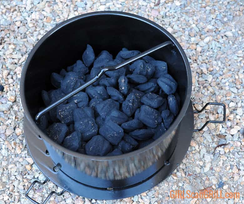 black metal basket full of coals.