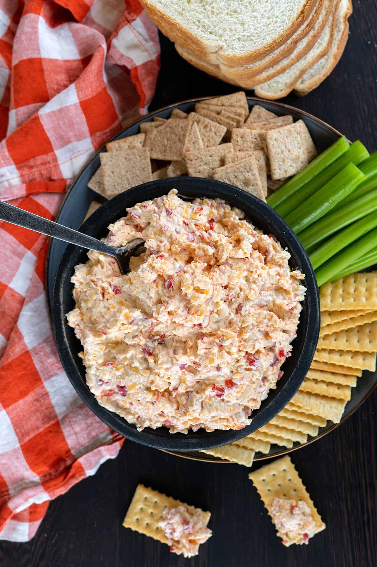 Overhead view of bowl of pimento cheese with crackers.