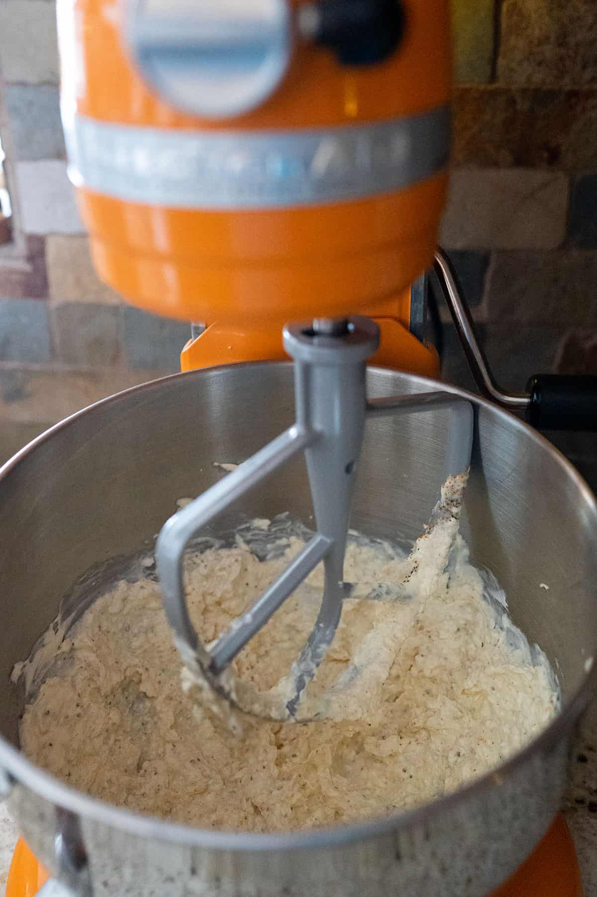 Creaming together cream cheese, mayo and seasonings in stand mixer.