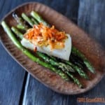 seared sea bass on asparagus topped with carrots