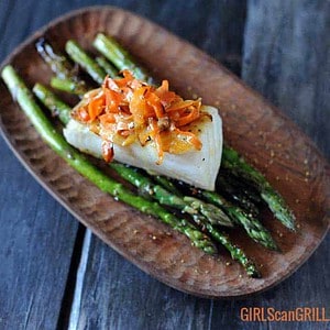 seared sea bass on asparagus topped with carrots