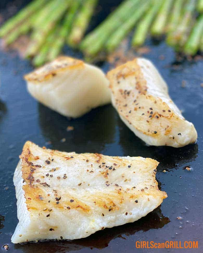 three sea bass filets on griddle