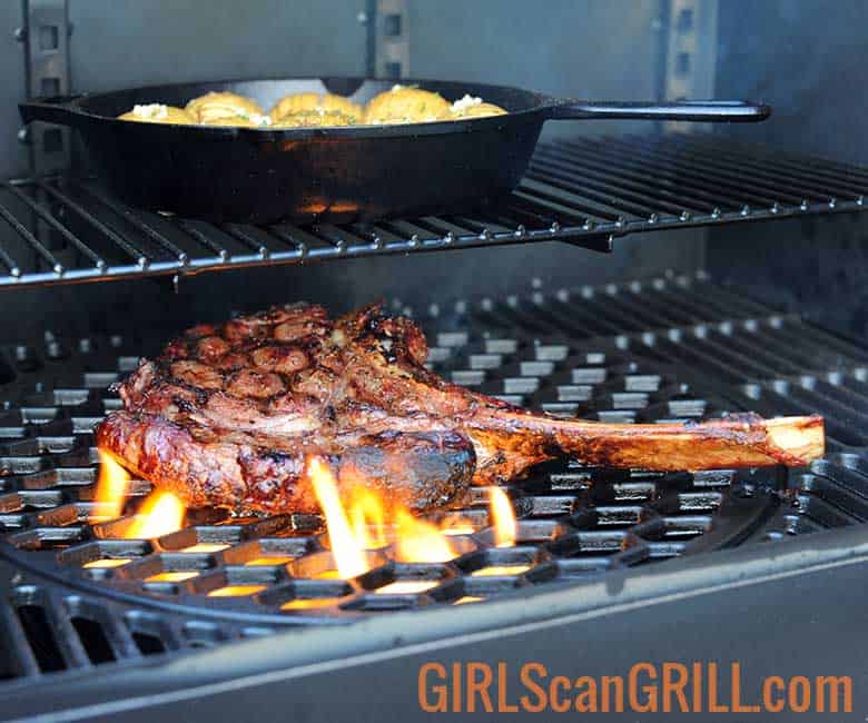ribeye steak on grate with flames
