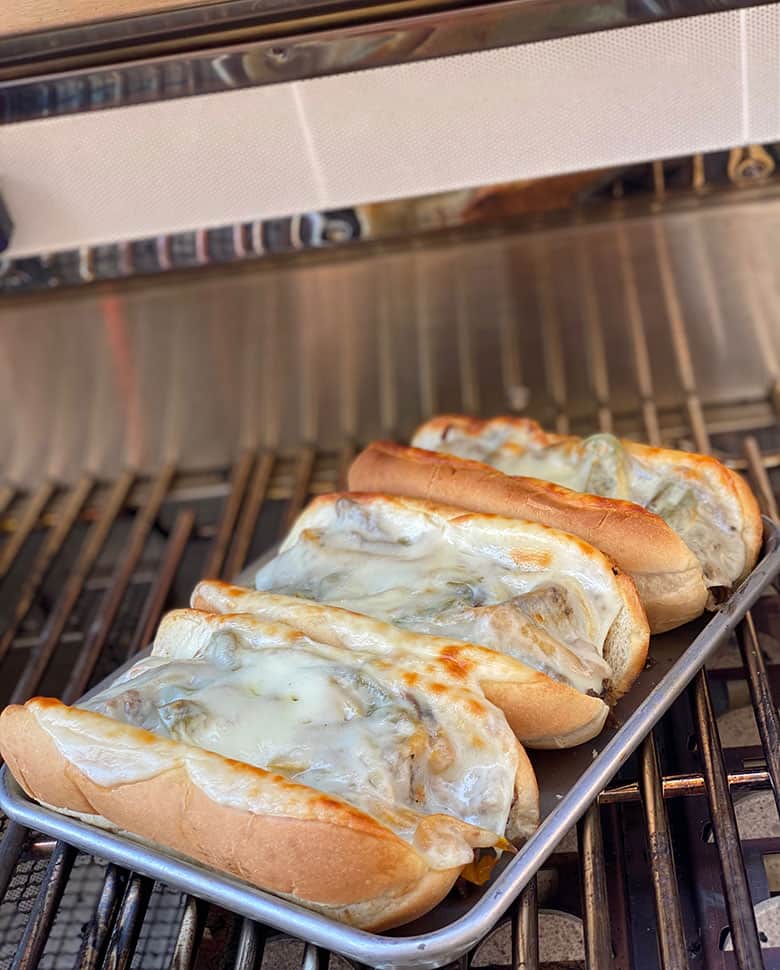 cheesesteaks on a grill