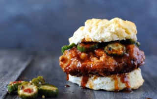 fried chicken on a biscuit with Nashville hot honey sauce and pickles