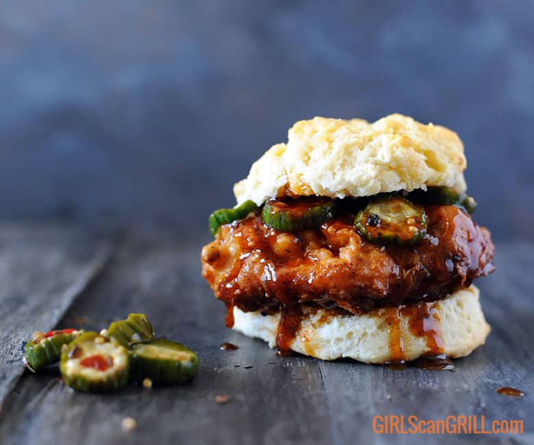fried chicken on a biscuit with Nashville hot honey sauce and pickles
