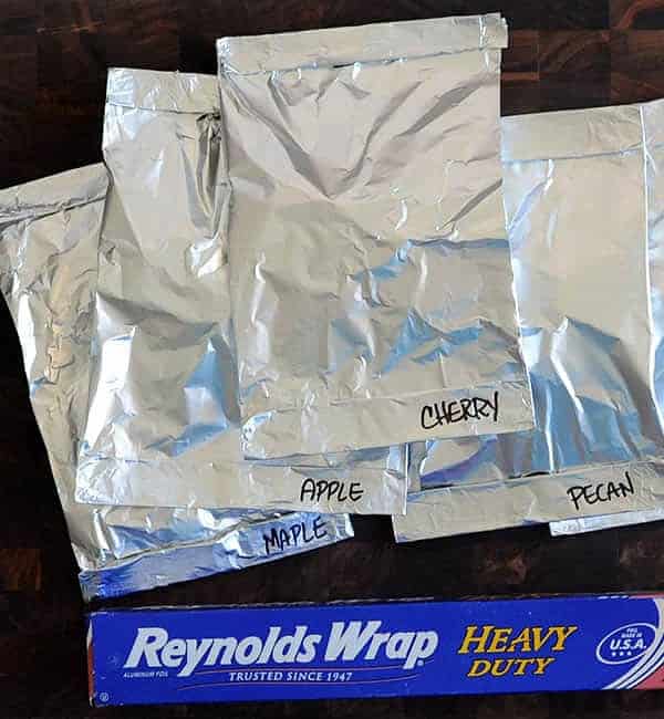 stack of foil pouches labeled with different woods