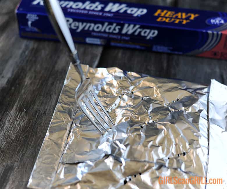 fork poking holes in foil pouch