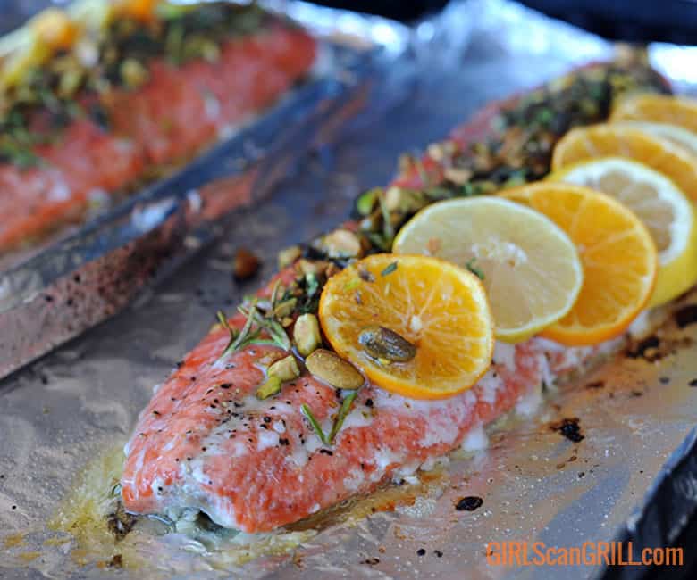 salmon on foil on grill with white oozing out.