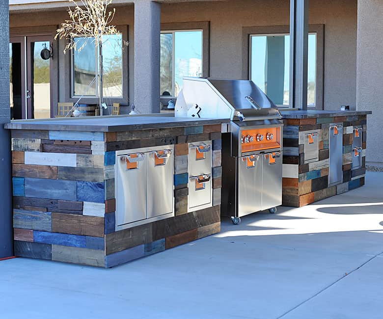 outdoor kitchen with grill and wood siding