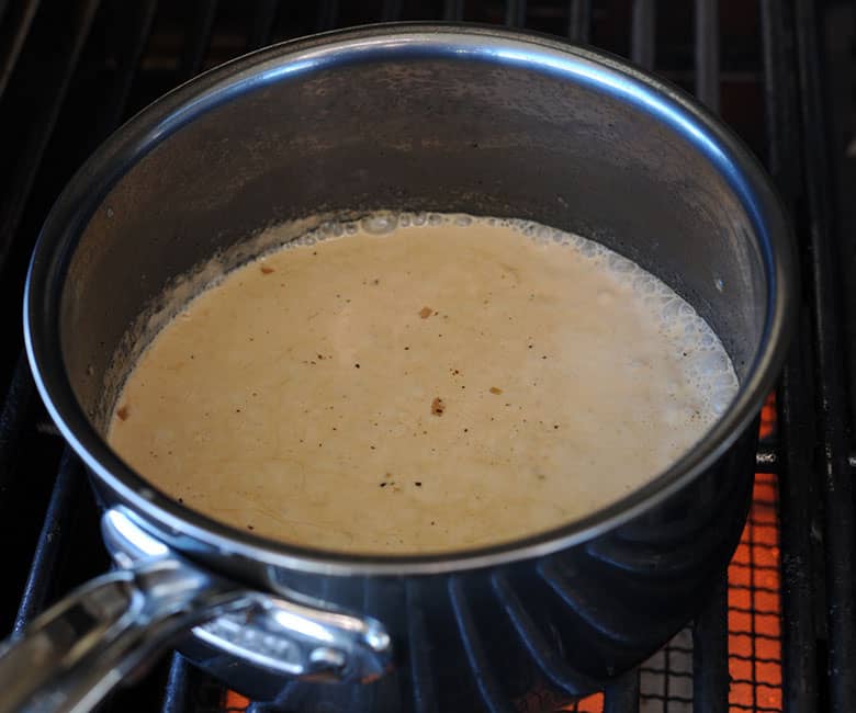 sauce pot with peppercorn sauce showing cream bubbling