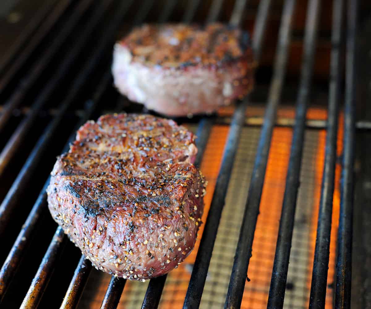 two filet mignons on grill.