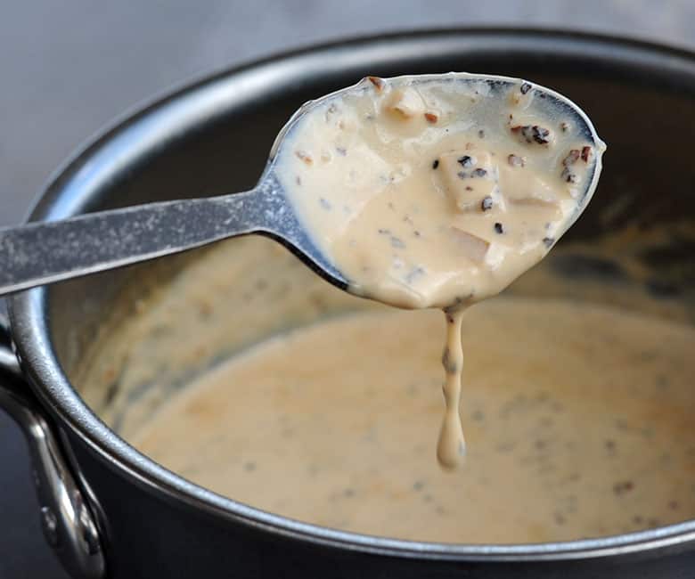 peppercorn sauce dripping off spoon