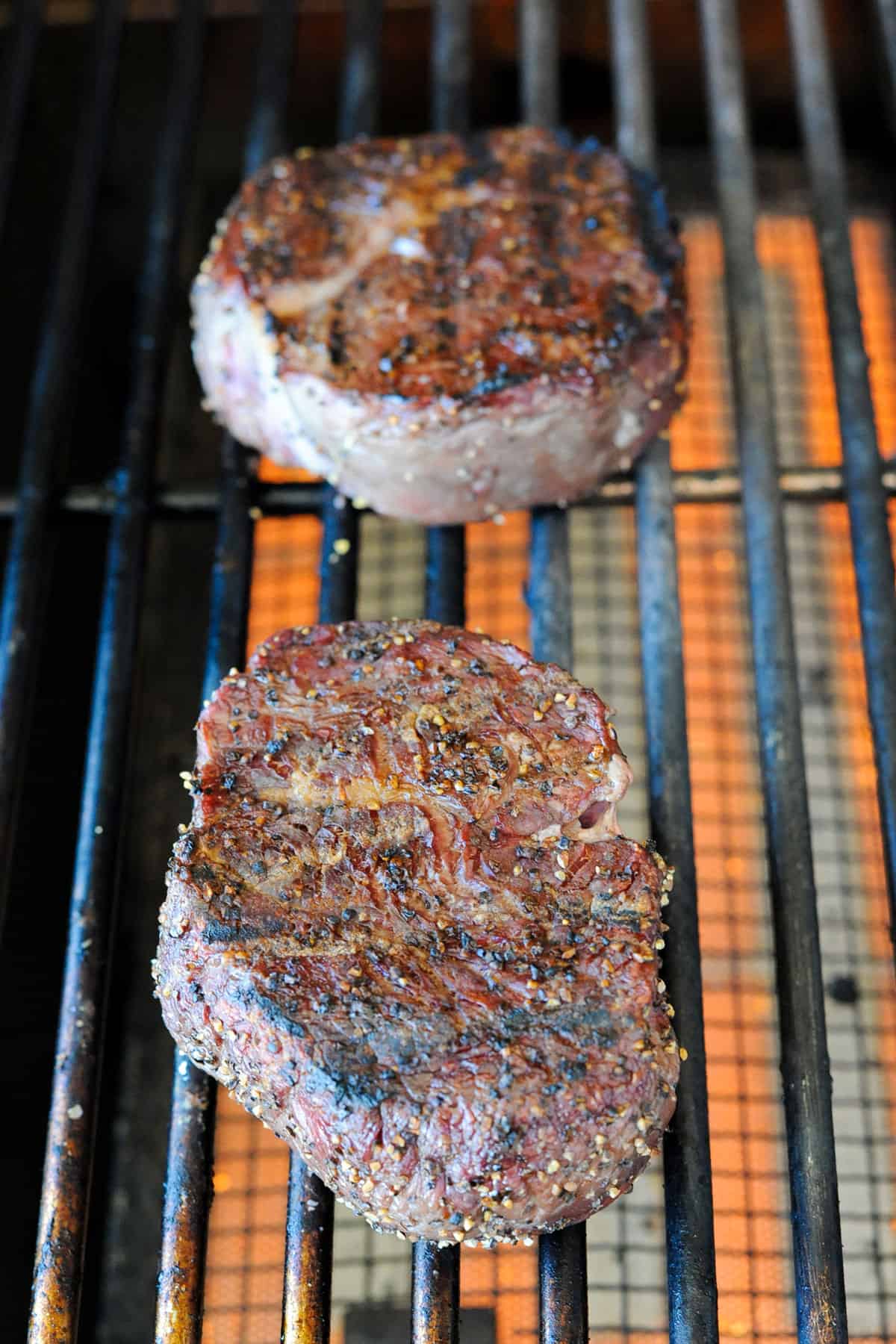 two filet mignons on grill.