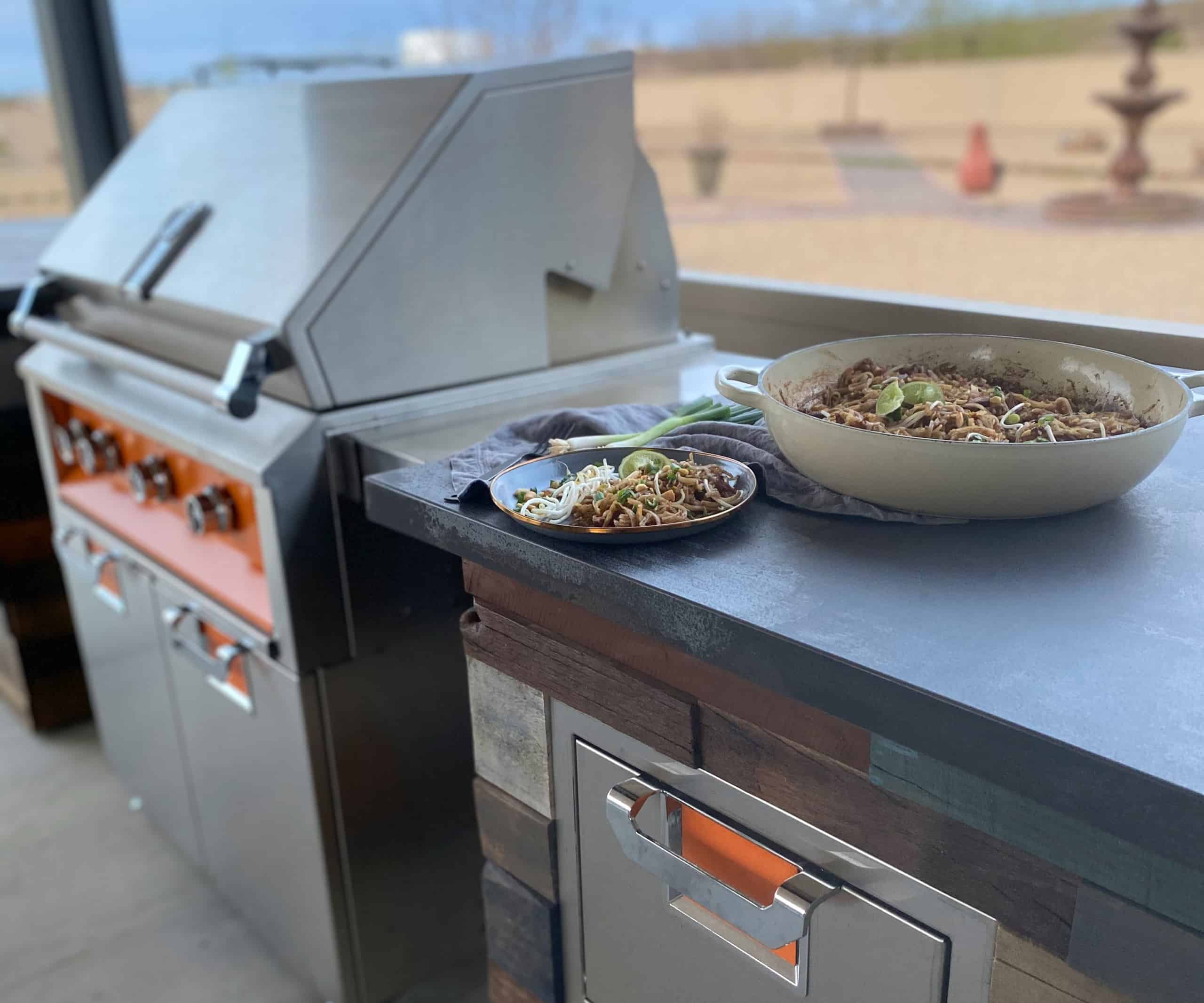 Grilled Pad Thai next to a grill on counter.
