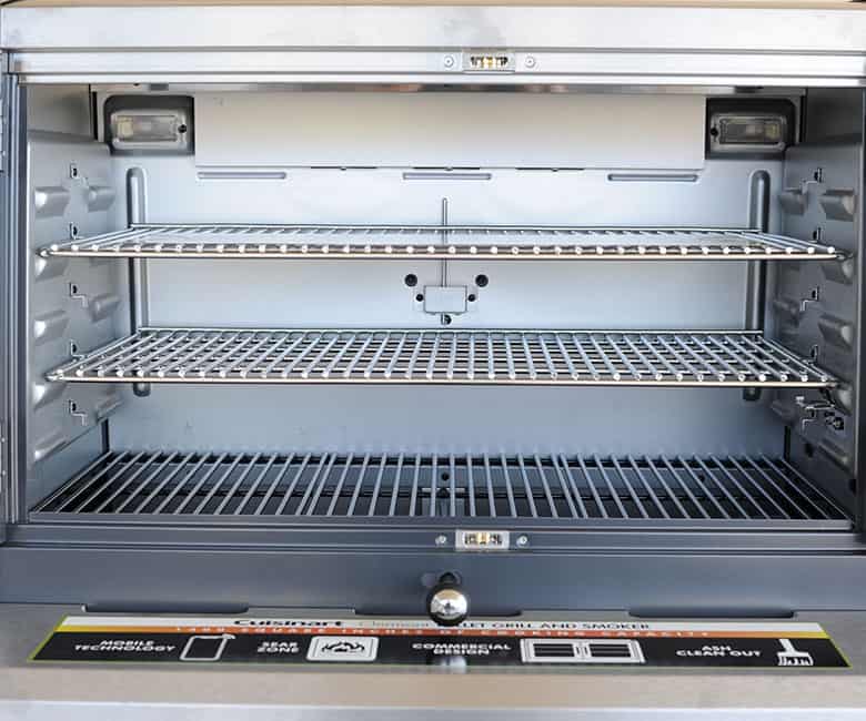 Interior of Clermont Pellet Grill showing two racks and a grate.