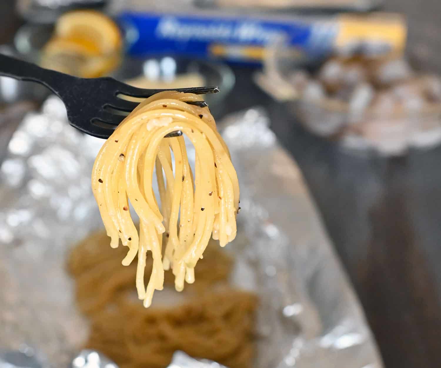 al dente noodles draped on a fork