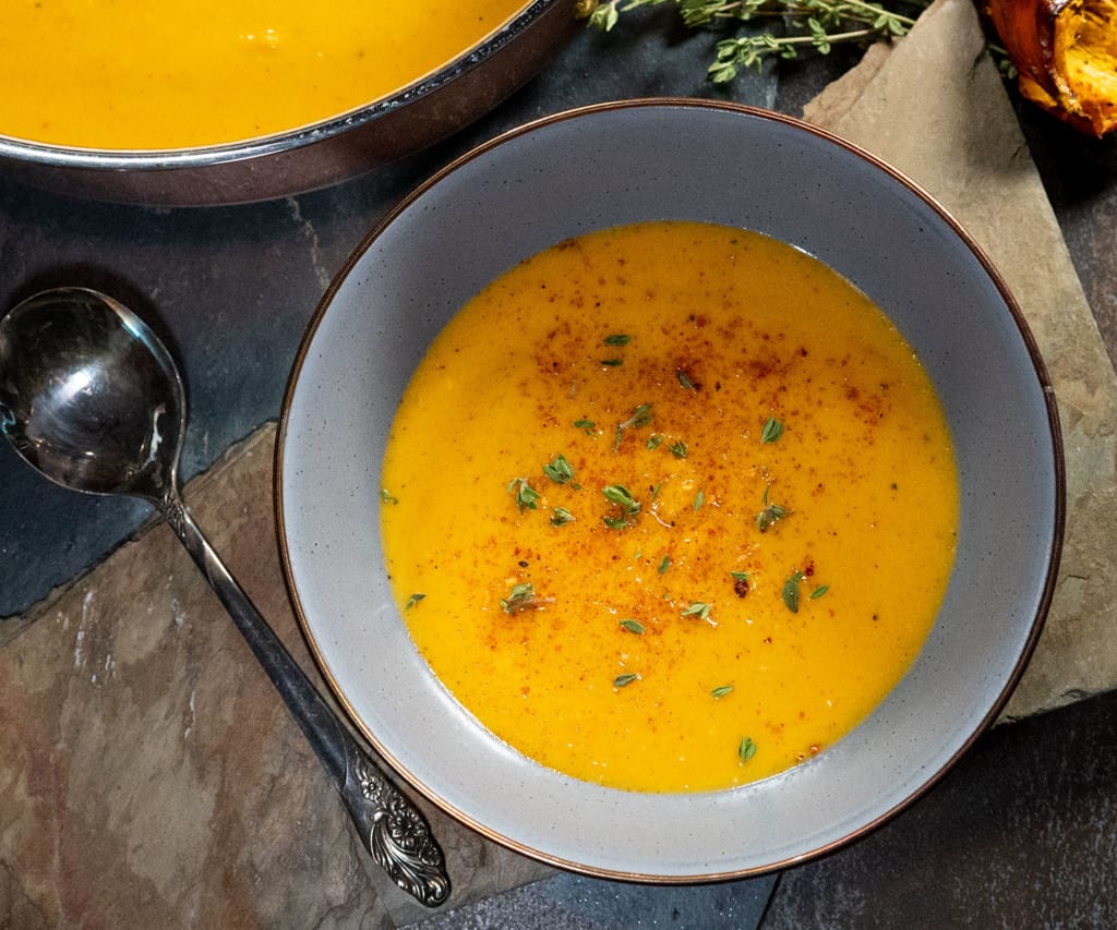 bowl of grilled butternut squash soup with herbs