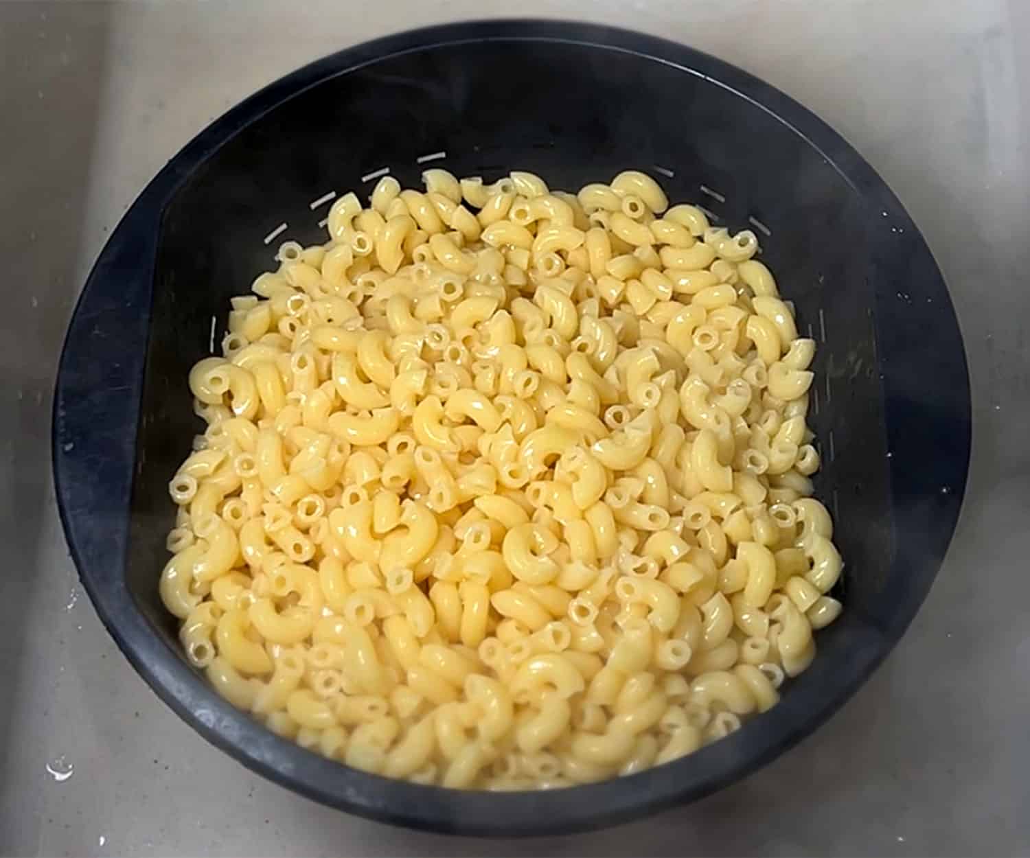 cooked macaroni in colander