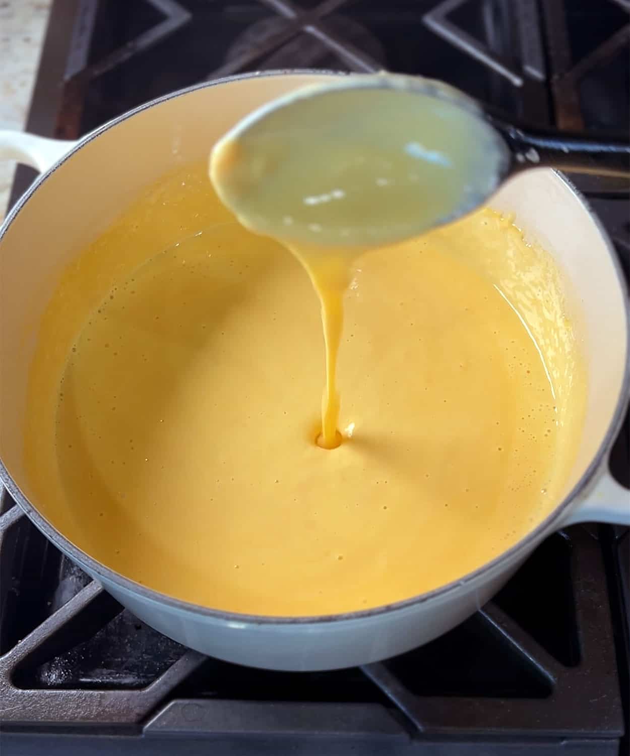 cheese sauce dripping off spoon