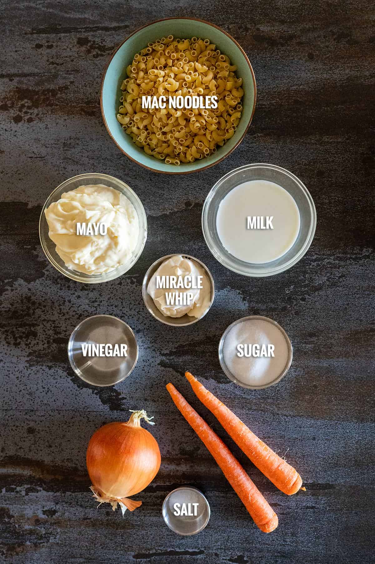 Hawaiian macaroni salad ingredients: noodles, mayo, Miracle Whip, milk, vinegar, sugar, onion and carrot.