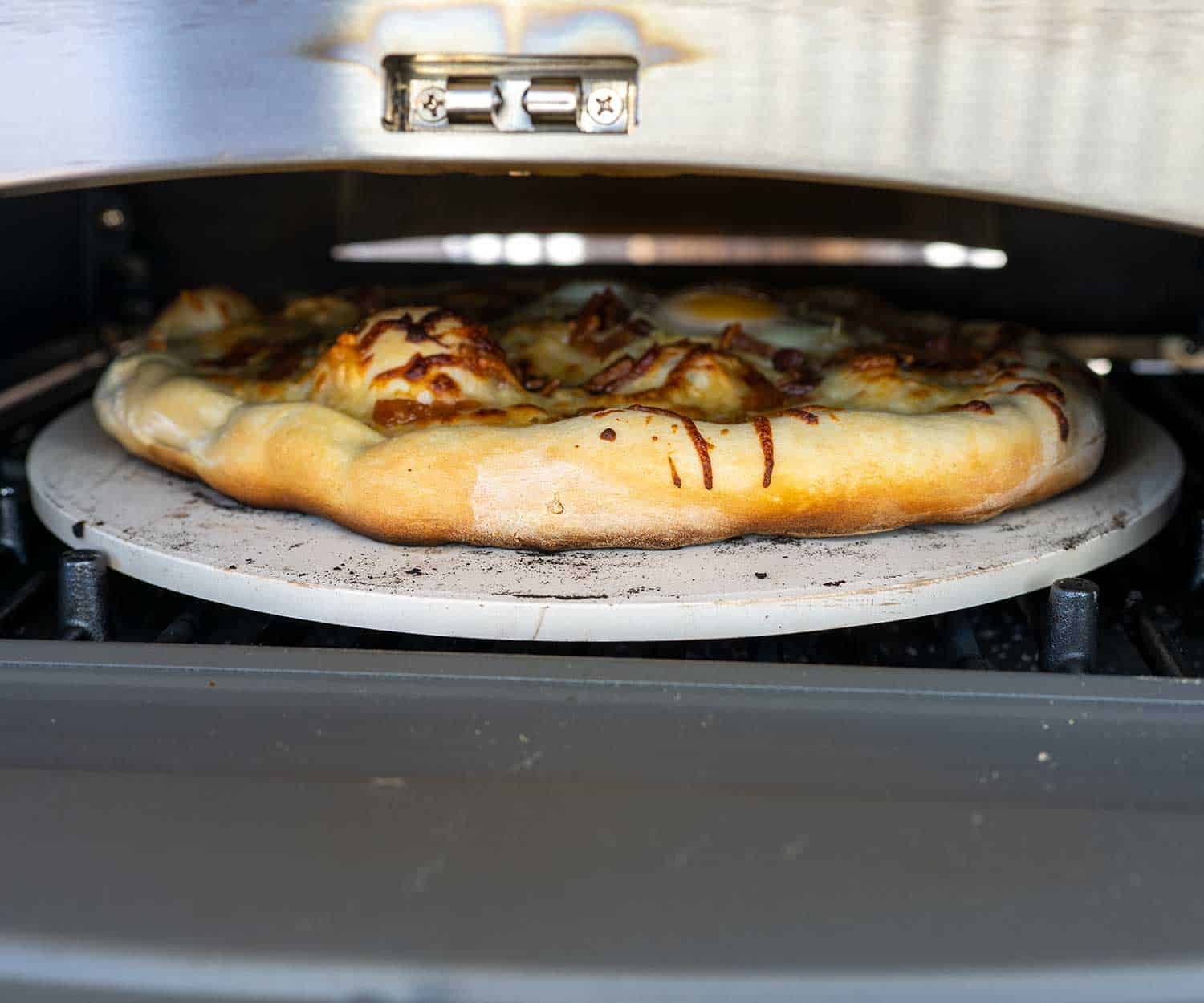 Cuisinart 3-in-1 Pizza Oven Plus with pizza on stone.