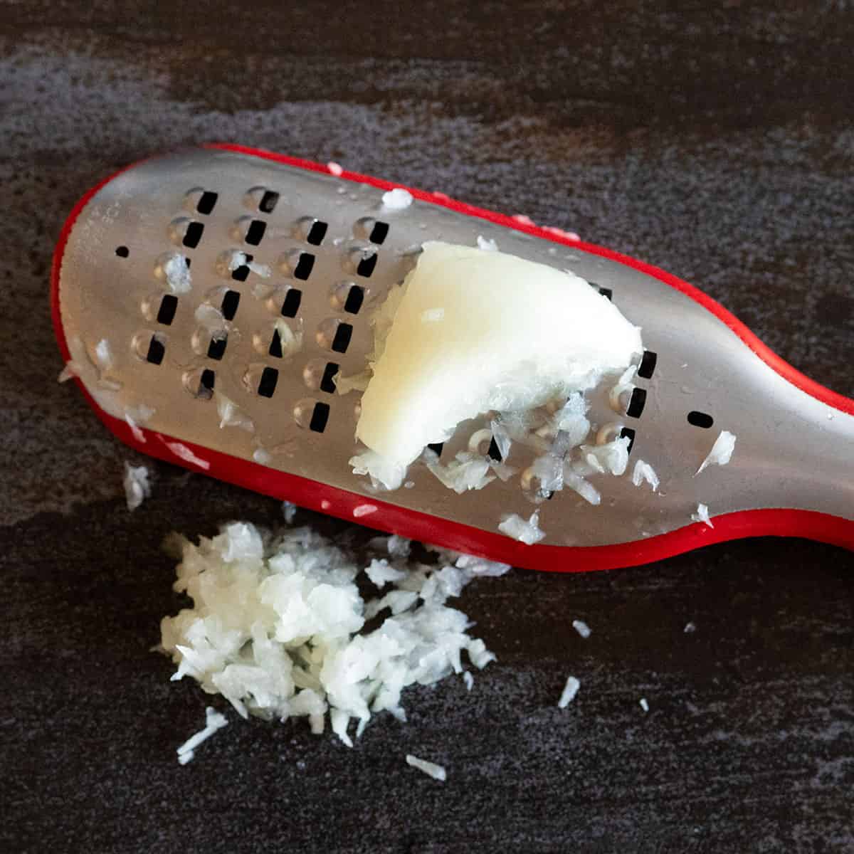 grating onion with a cheese grater.