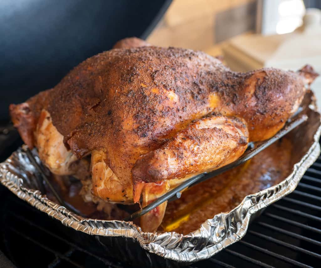 smoked turkey on pan on grill