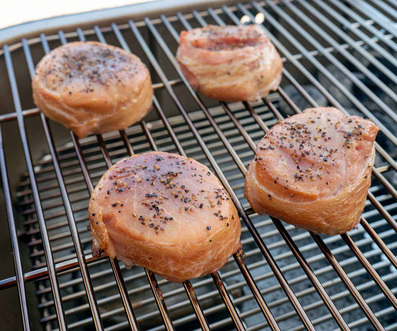 bacon-wrapped pork loin filets on grill