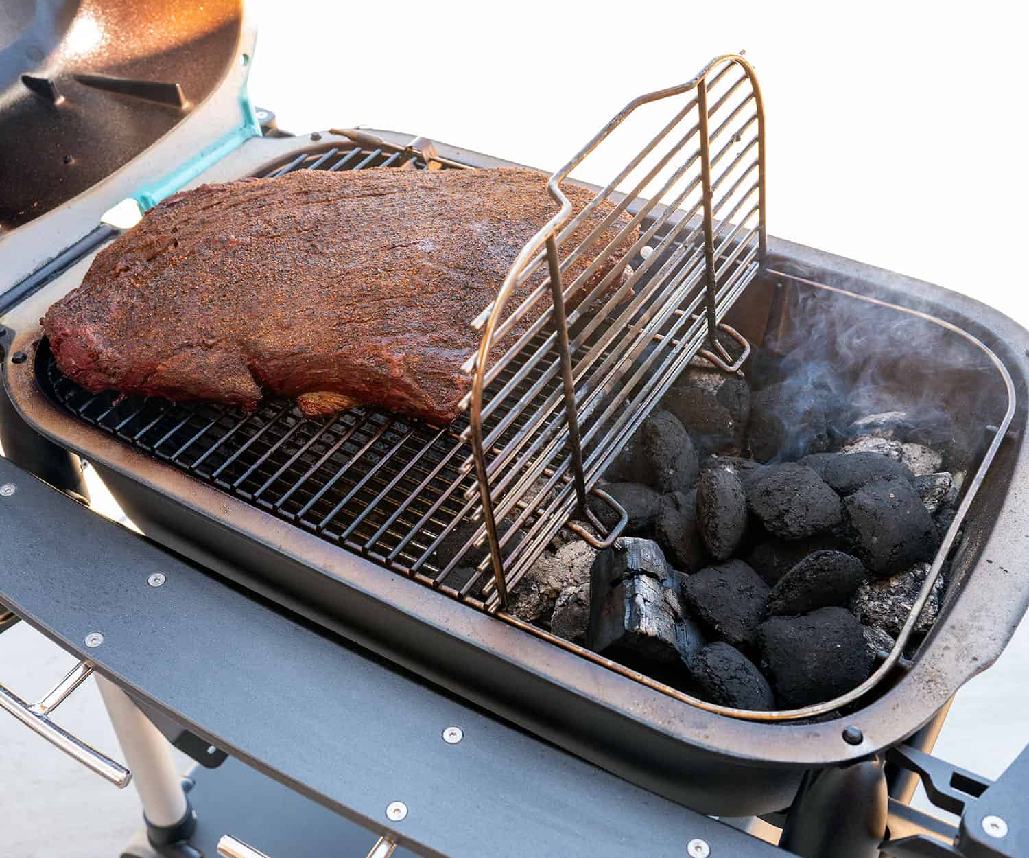 brisket smoking on PK Grill with hinge grate open