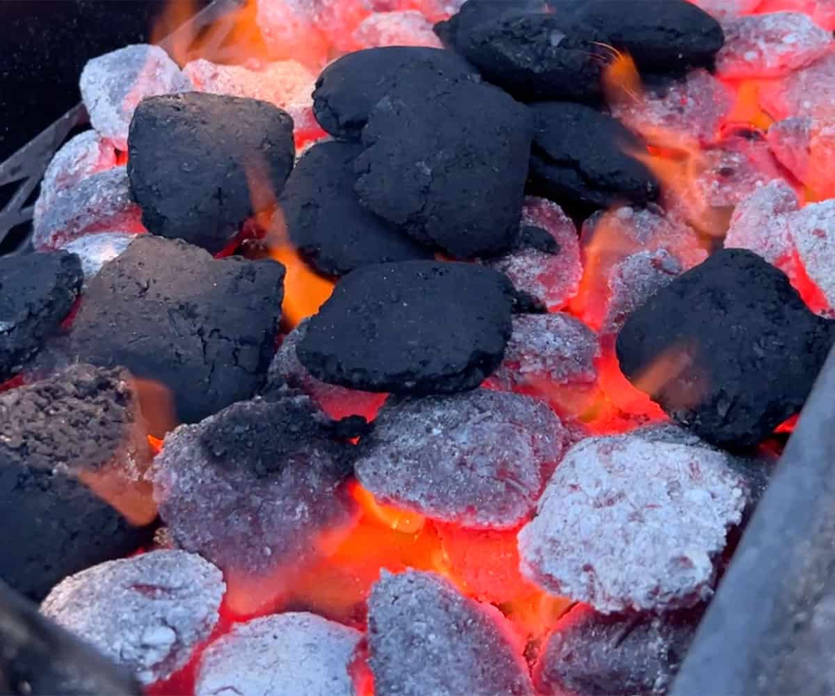 charcoal briquets burning in grill.
