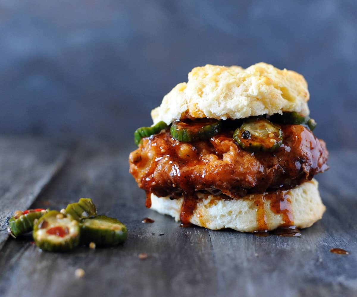 Nashville hot chicken on biscuit with honey and pickles.