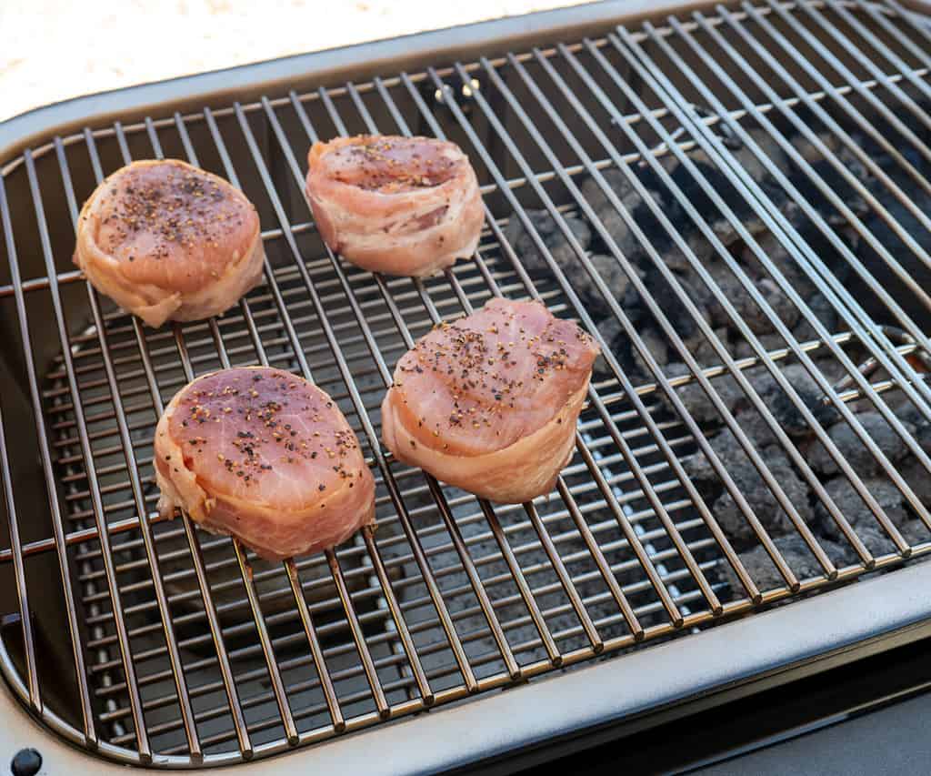 4 pork filets smoking over indirect heat on a PK Grill