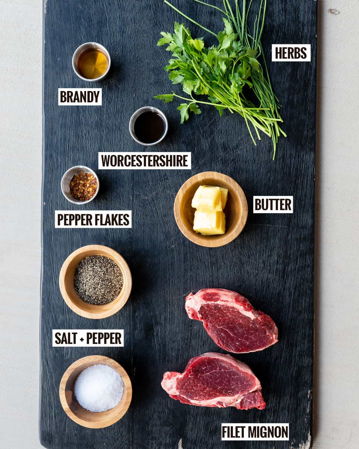 Steak Diane ingredients: herbs, brandy, worcestershire sauce, butter, pepper flakes, salt, pepper, filet mignon.