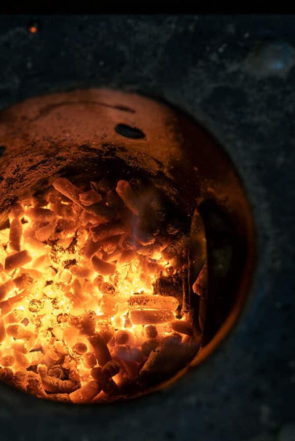 wood pellets burning in a pellet grill fire pot.
